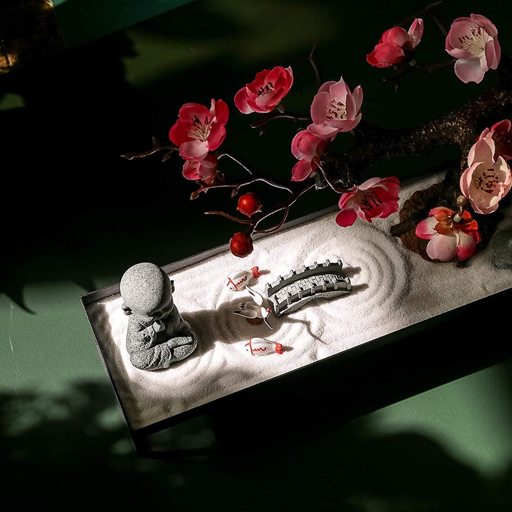 Beautiful miniature zen garden with incense sticks on table