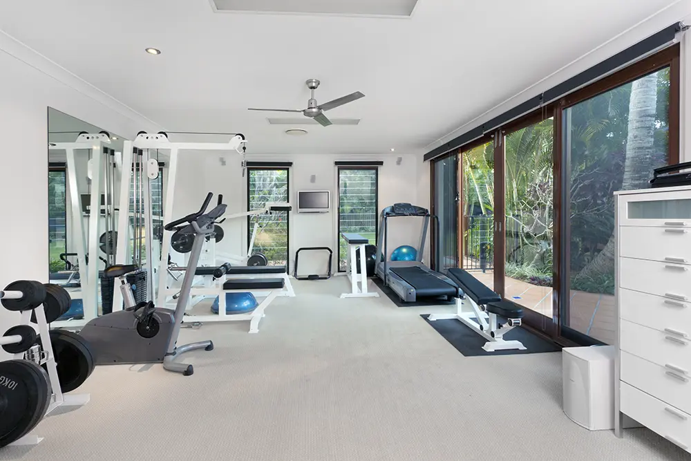 Innovative Storage Solutions for a Clutter-Free Home Gym”, by Oasis Away