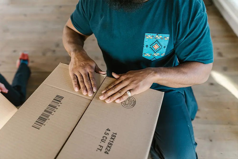 Picture of a person sealing a box